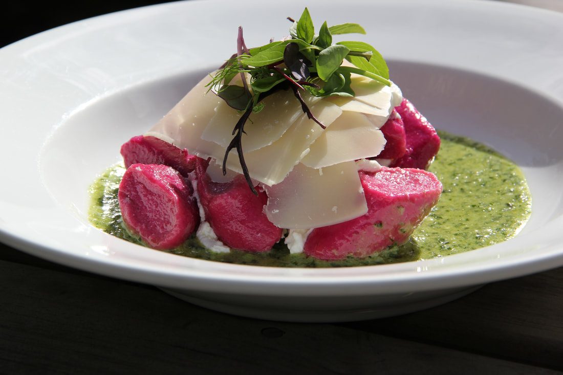 Beetroot gnocchi with shaved cheese